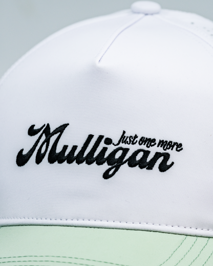 Close-up of a white golf cap with black embroidered text reading &